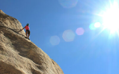 Hard makes it great: Climber about to reach a mountain top